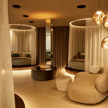 Luxury spa lounge with round seating areas, ambient lighting and modern decor