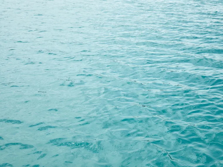 Clear turquoise ocean water with gentle surface ripples