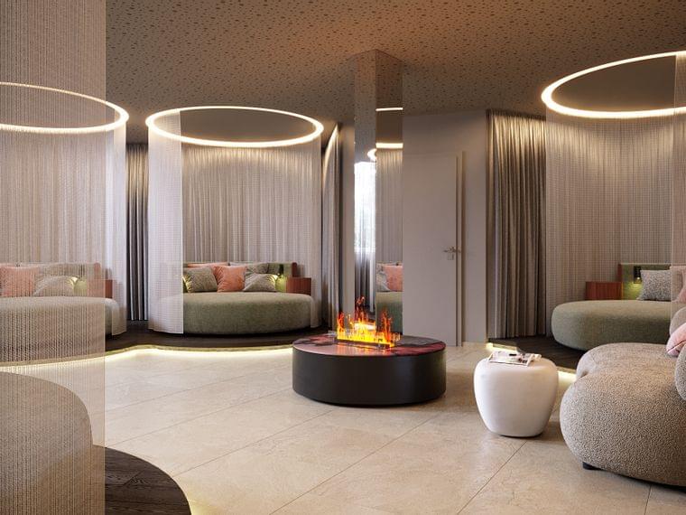 Moderner Spa-Loungebereich mit runden Betten, transparenten Vorhängen, Ambientebeleuchtung und Kamin
