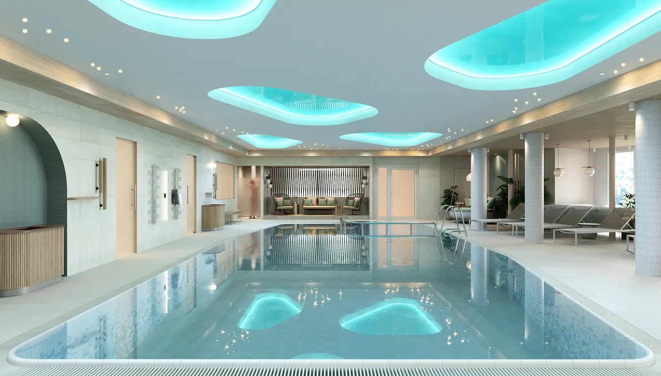 Luxuriöser Innenpool im Spa mit Liegestühlen, stimmungsvoller Beleuchtung und modernem Design