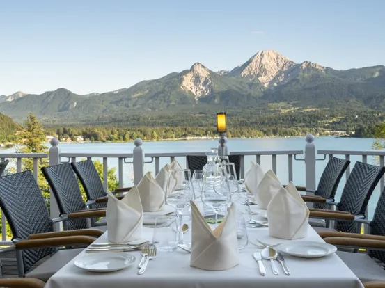 Elegant gedeckter Außentisch mit Blick auf See und Bergpanorama im Sommer