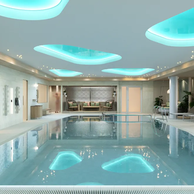 Luxuriöser Innenpool im Spa mit Liegestühlen, stimmungsvoller Beleuchtung und modernem Design